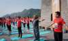 Indians and Chinese practice yoga at Great Wall