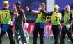 Australia's Adam Zampa, centre, is congratulated by teammates after taking the wicket of Bangladesh