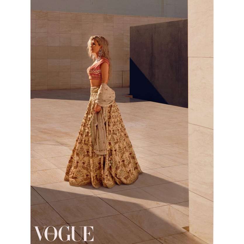 Few days back, a pic from the shoot was shared by Vogue in which the lady donned beige lehenga with red blouse designed by Anita Dongre.