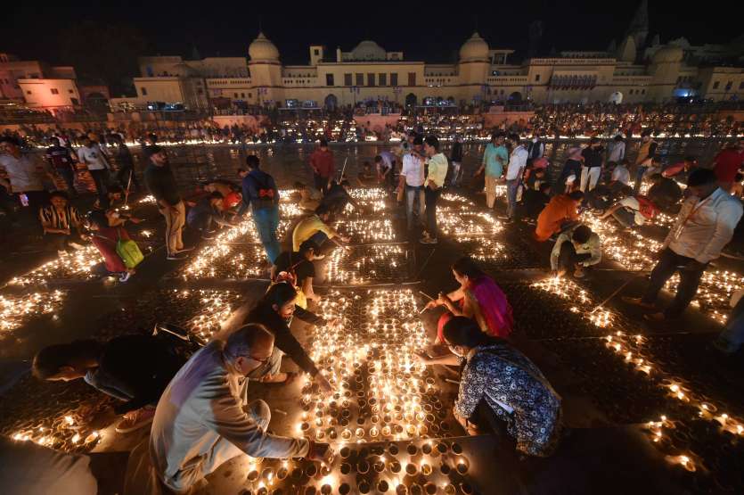 Devotees light earthen lamps on the bank of Saryu River during Deepotsav celebrations in Ayodhya