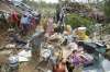  A woman sorts valuable items recovered from her damaged