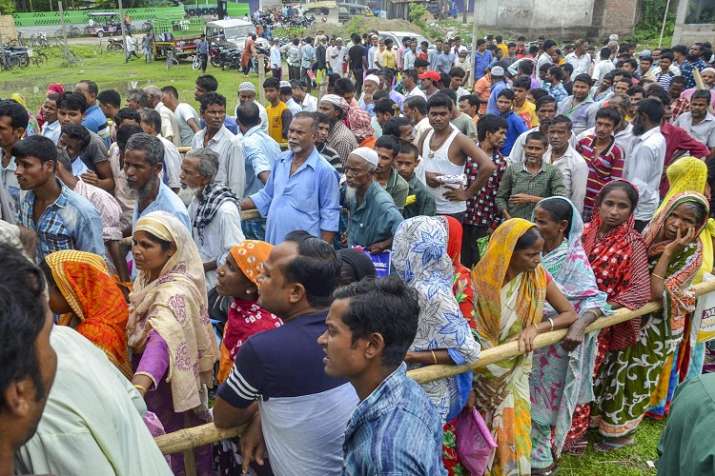 People wait to check their names on the final draft of the