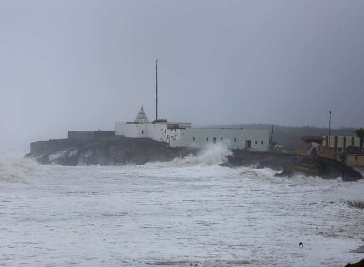 Huge wave hits the wall of a temple along the seashore
