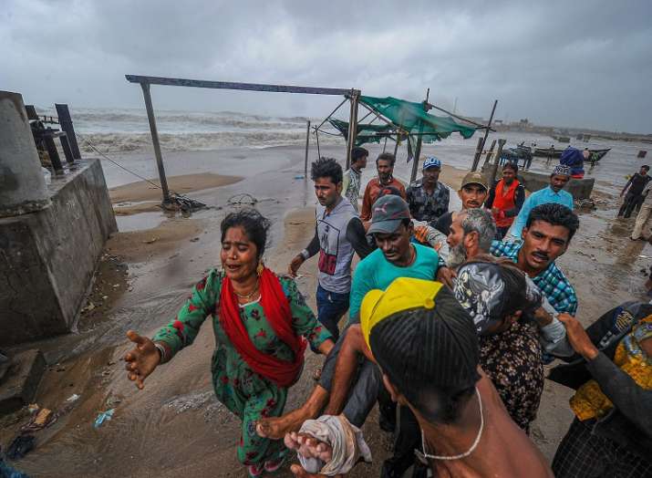 People carry an elderly man who was injured as strong